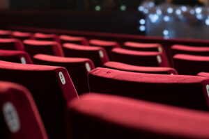 Empty theater with red chairs. Rear view.