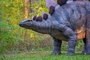 Big model of prehistoric dinosaur in nature. Realistic scenery.