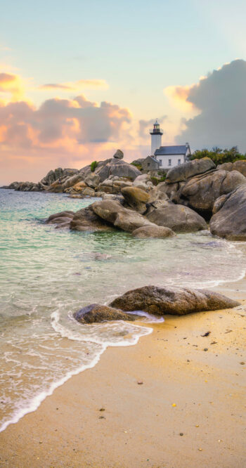 The Pontusval lighthouse, located on a rocky point in northern Finistere in Brittany, overlooks a sea of transparent turquoise waters during sunrise The Pontusval lighthouse, located on a rocky point in northern Finistere in Brittany, overlooks a sea of transparent turquoise waters during sunrise.